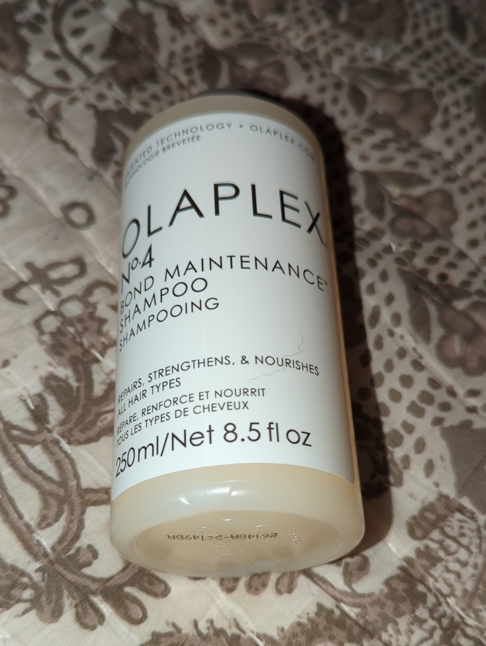 OLAPLEX No.4 Bond Maintenance Shampoo — White Bottle with Black Text